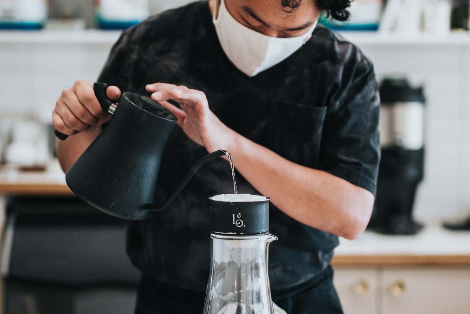 Barista pouring coffee in a coffee shop